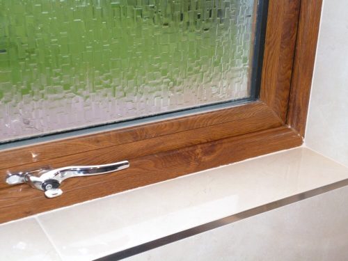 Interior view of timber window and hardware with privacy glass